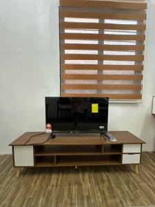 a living room with a coffee table in front of a window at Seriemas Angler Venture Homestay in Sepang