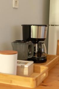 a coffee maker sitting on top of a wooden table at Scala Room 68 in Ioannina