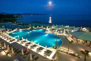 an aerial view of a resort pool at night at Trypiti Resort Blue Dream Palace and Hive Water Park in Limenaria