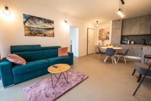 a living room with a green couch and a table at Luxury Apartment Marija in Novalja