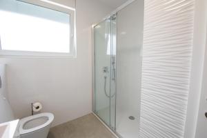 a bathroom with a toilet and a glass shower at Luxury Apartment Marija in Novalja +40 photos