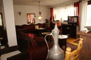 a living room with a couch and a television at Villa Velagic in Blagaj
