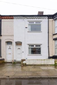 a white house with white doors and windows at Charming 5-Bedrooms in the Heart of Liverpool - By Resify in Liverpool