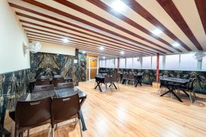 a dining room with tables and chairs in a building at Treebo Trend Kharadi Residency - Near EON IT Park in Pune