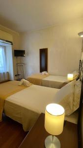 Postelja oz. postelje v sobi nastanitve Holiday Suite Roma