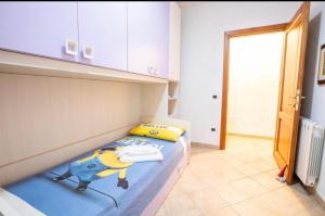 a small bedroom with a bed with a cartoon character on it at Sorin's house in Olbia