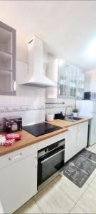 a kitchen with white cabinets and a sink at CANDELARIA SOL Y MAR in Candelaria