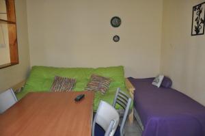 a living room with a green couch and a table at HUGO 3 in Colón