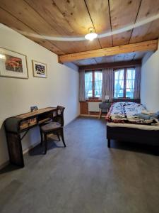a bedroom with a desk and a bed in a room at Gasthof Kreuz Marbach in Marbach