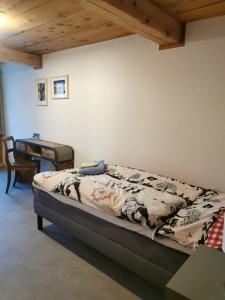 a bed in a room with a desk and a bed sidx sidx sidx at Gasthof Kreuz Marbach in Marbach