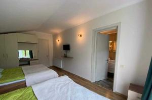 a bedroom with two beds and a television in it at 2.040 in Bakuriani
