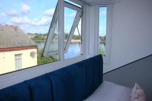 a room with a window with a blue couch and a view at The Birmingham Boutique in Birmingham