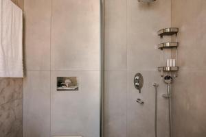 a shower stall with a toilet in a bathroom at Argostoli Cityscape Apartment in Argostoli
