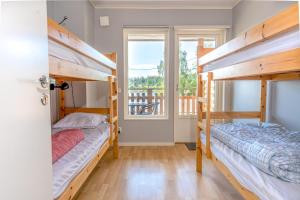 a bedroom with two bunk beds and a balcony at Vimmerby Camping in Vimmerby