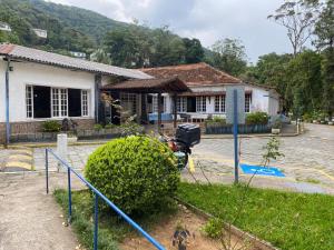 a house with a fence in front of it at ASCB Petrópolis in Petrópolis