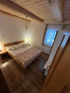 a bedroom with a bed and a large window at Penzión Skorušina in Brezovica