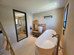 a bathroom with a white tub and a sink at Villa prestige au bord de l'eau- Misincu in Cagnano +42 photos