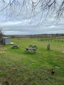 a group of picnic tables in a field at Static Mobile home set in our 20 acres of farmland in Horspath