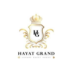 a vintage heraldic logo with a crown at Hayat Grand Guest House in Islamabad