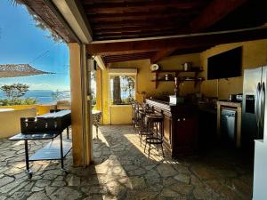 a kitchen with a view of the ocean at Villa La Renarde in Le Lavandou