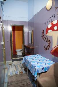 a room with a bathroom with a bed and a toilet at Chillout Lya Hostel & Lounge in Istanbul