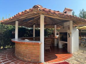 eine Terrasse mit einer Außenküche mit einem Pizzaofen in der Unterkunft Finca Villa Maria - Cabaña in Ráquira