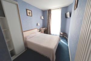 En eller flere senge i et værelse på Hotel Royal Bergère