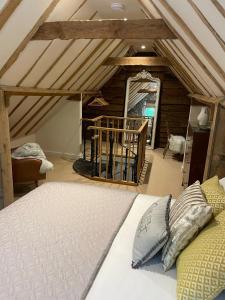 a bedroom with a bed in a attic at The Manor Pen in Lenham