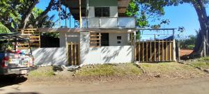 a house under construction on the side of the road at ALOHA BEACH FROM HOUSE in Parrita