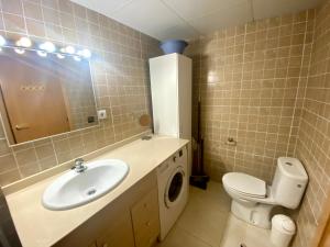 a bathroom with a sink and a washing machine at Apartamento en Pinar de la Cala - D in L'Ametlla de Mar +20 photos