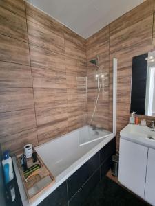 a bathroom with a bath tub and a sink at Le Claussat #Hypercentre #Parking in Chamalières