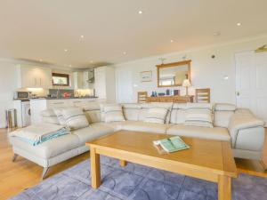 a living room with a white couch and a table at 19 Burgh Island Causeway in Kingsbridge