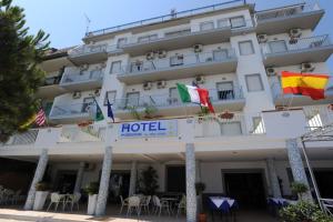 a hotel with flags in front of a building at Hotel Poseidon in Corigliano Calabro