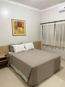 Cama ou camas em um quarto em Hotel Jardim
