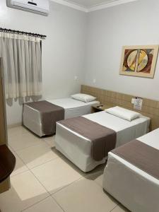 Cama ou camas em um quarto em Hotel Jardim
