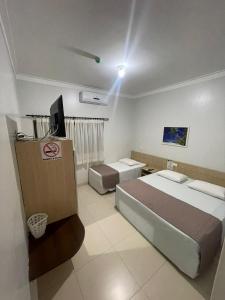 Cama ou camas em um quarto em Hotel Jardim