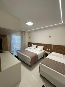 Cama ou camas em um quarto em Hotel Jardim