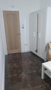 a room with white walls and a floor with brown tiles at Private Room with attached Bathroom in The Hyde