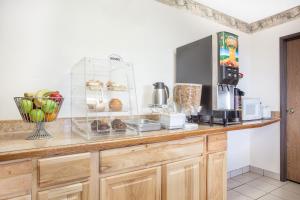 a kitchen with a counter with a microwave and some food at FairBridge Inn & Suites Moscow - Pullman in Moscow