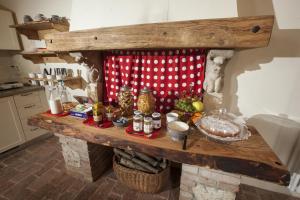 a kitchen with a stone fireplace with food on it at Fattoria Le Vegre in Arcugnano