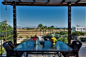 a blue table with fruit on top of a balcony at XENOS VILLA 2 near the sea in Tigaki