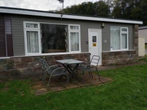 a table and chairs in front of a house at Sea views in Bideford