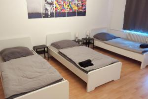 a room with two beds and two side tables at Nice Appartement in Trappenkamp in Trappenkamp