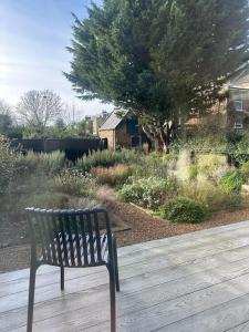 a bench sitting on top of a wooden deck at Lewknor Lodge: Stunning 5 bed, 4 bathroom house in Ramsgate in Kent