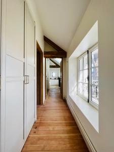 a hallway of a house with white walls and wooden floors at Le Clos Ste Thérèse by Idylliq 