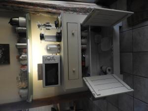a kitchen with an open door and a stove at Bed&Breakfast 't Eikeltje in Hollandscheveld