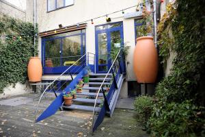 a house with a blue staircase in front of a building at Solar Hotel in Paris
