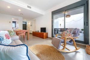 a living room with a couch and chairs and a table at Casa Calafat in Calafat