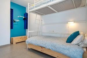 a bedroom with a bunk bed with a ladder at Casa Calafat in Calafat