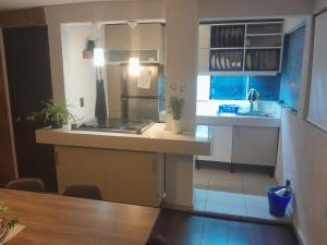 a kitchen with a sink and a counter top at Casa Bosques in Cuautitlán Izcalli +43 photos